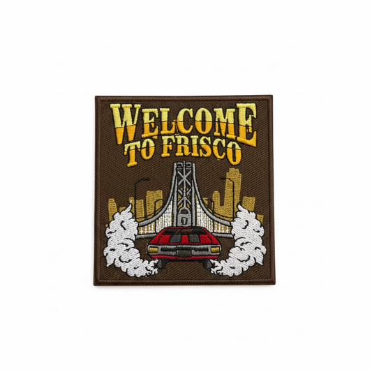 Embroidered patch with 'Welcome to Frisco' text and a car design on a brown background.